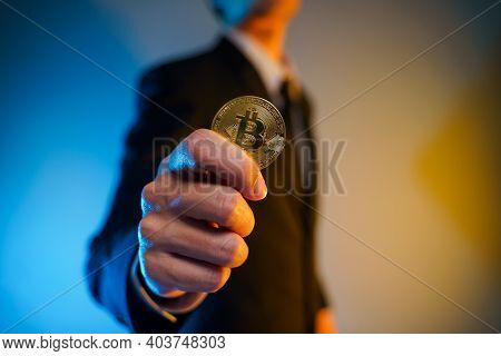 Close Up Shot Of Businessman Holding Golden Coin.
