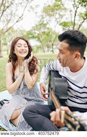 Happy Excited Young Woman Applauding Her Boyfriend Singing And Playing Guitar When Thay Are Having R
