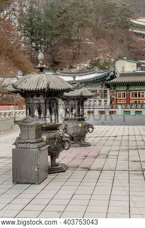 Danyang-gun, South Korea; Jan. 13, 2021: Two Ornate Metal Incense Candle Burners On Patio Of Guinsa 