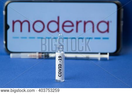 Krasnodar, Russia - January 12, 2021: Medicine Ampoule With The Covid-19 Label Over The Moderna Logo