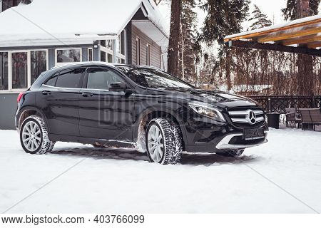 MOSCOW, RUSSIA-JANUARY 10, 2021: Black luxury crossover Mercedes Benz GLA 250 on a suburban plot in