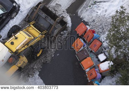 Madrid, Spain - January 17, 2021: An Excavator Machine, Snow Plow, Clears And Tears The Ice From The