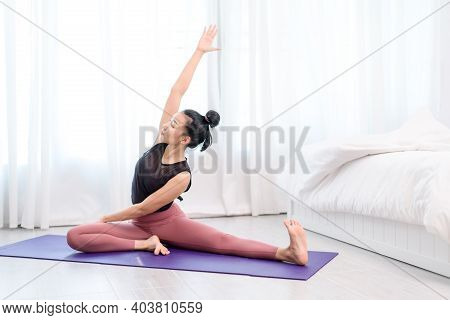 Young Woman Do Yoga In A Bed Room