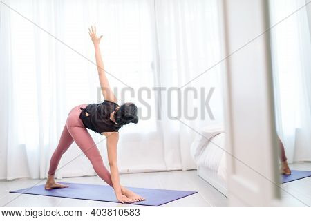 Young Woman Do Yoga In A Bed Room