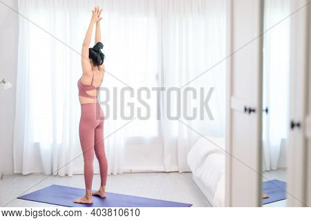 Young Woman Do Yoga In A Bed Room