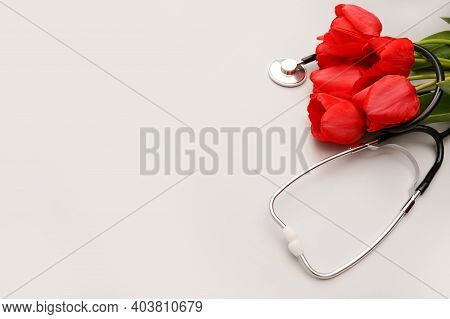 Bunch Of Redtulips And Stethoscope On White Background. National Doctor's Day. Happy Nurse Day. Top 