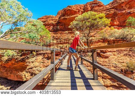 Caucasian Tourist Woman At Kings Canyon Rim Walk With Foot Bridge Over The Garden Of Eden In Watarrk