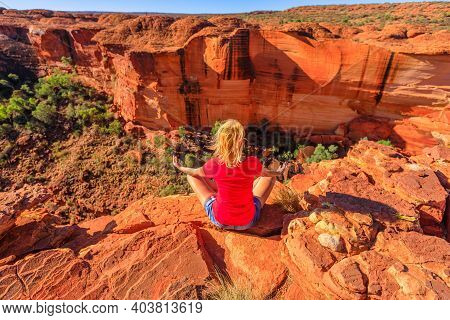 Peaceful Woman Doing Yoga Meditation In Lotus Pose At Edge Of Kings Canyon In Watarrka National Park