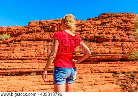 Tourism In Northern Territory Nt, Australia. Tourist Woman Looking Tall, Rugged Vertical Rock Walls 