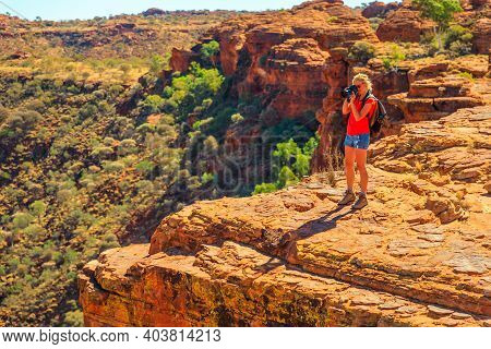 Travel Photographer Taking Pictures Of Sandstone Cliff In Kings Canyon Watarrka National Park. Centr