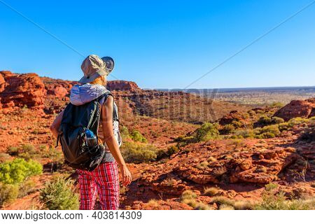 Backpacker Woman Tourist Looking Rugged Rock And Deep Gorge Of Kings Canyon In Red Center Outback At