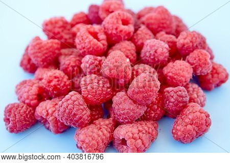Raspberry Pattern, Blue Background, Top View\rpattern Of Ripe Red Raspberry On Blue Background. Vega