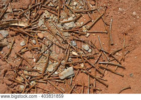 Rusty. Used rusty and crooked nails thrown on earth and gravel floor used in civil construction, Brazil, South America