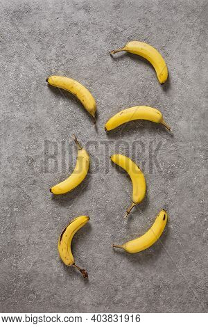 Ripe Bananas On Gray Concrete Background. Interior Photo. Photoart.