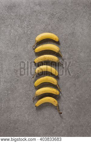 Ripe Bananas On Gray Concrete Background. Interior Photo. Photoart.