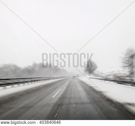 Driving A Car On Icing Snowy Winter Highway. Point Of View Pov During Driving A Car In Winter Season