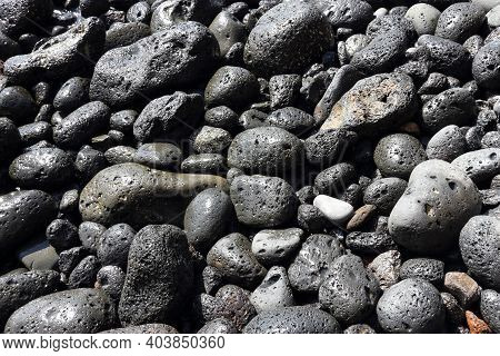 Scoria Igneous Rocks In Tenerife. Rounded Black Stones.