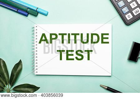 Aptitude Test Is Written On A White Sheet On A Blue Background Near The Stationery And The Scheffler