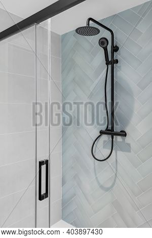 Modern Shower Zone With Rain Head, Hand Held Shower And Glass Door. Light Blue And White Tiles In Th
