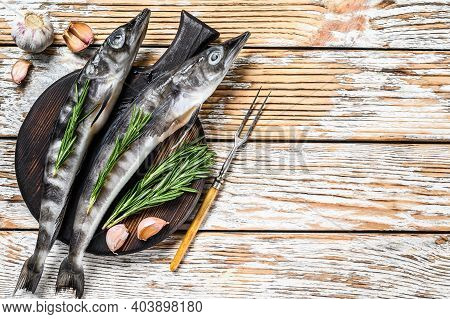 Raw Whole Icefish With Herbs. White Wooden Background. Top View. Copy Space