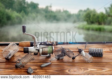 Fishing Tackle And Accessories On The Table Against The Background Of A Lake. Selective Focus
