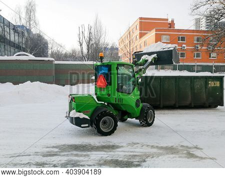 Moscow. Russia. January 15, 2021. Small Front-end Loaders Clear Snow From The Street And Load Into A