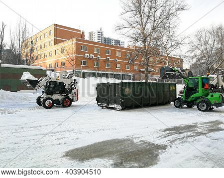 Moscow. Russia. January 15, 2021. Small Front-end Loaders Clear Snow From The Street And Load Into A