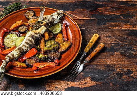 Baked Whole Icefish With Grilled Vegetables. Dark Wooden Background. Top View