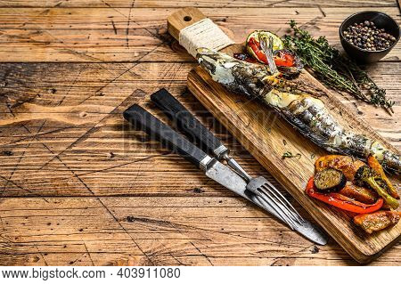 Grilled Whole Icefish With Vegetables. Wooden Background. Top View. Copy Space