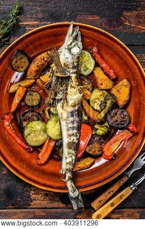 Baked Whole Icefish With Grilled Vegetables. Dark Wooden Background. Top View
