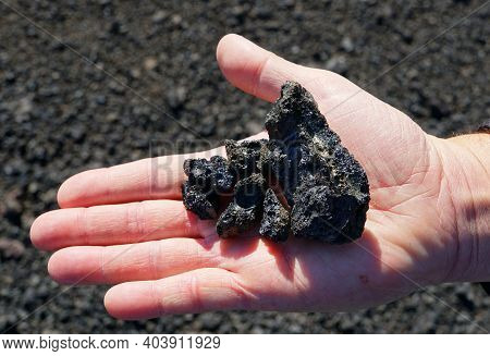 Holding The Igneous Rock Formed From The Volcanic Eruption At Krafla Lava Field Near Myvatn, Iceland