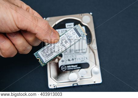 Paris, France - Jan 2, 2018: Pov Male Hand Holding Comparing Large Hdd Hard Disk Drive From Western 