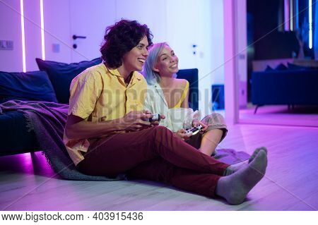 Handsome Young Man Teaching How To Play The Video Games To His Girlfriend, On The Couch, Concept Abo