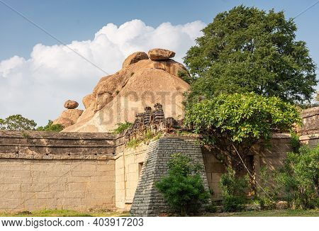 Hampi, Karnataka, India - November 5, 2013: Malyavanta Raghunatha Temple. Brown Boulders Peep Over O