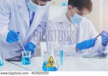 Two Asian Scientist Team Reserch Chemistry Science Tube Experiment Biotech Antibody Sample In Labora