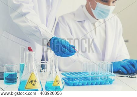 Two Asian Scientist Team Reserch Chemistry Science Tube Experiment Biotech Antibody Sample In Labora
