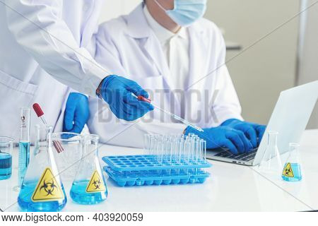 Two Asian Scientist Team Reserch Chemistry Science Tube Experiment Biotech Antibody Sample In Labora