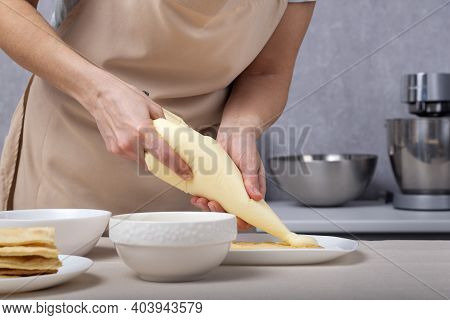 Pastry Chef Squeezes Cream Out Of The Culinary Bag. Pastry Bag. Cream Injector. Culinary Syringe.