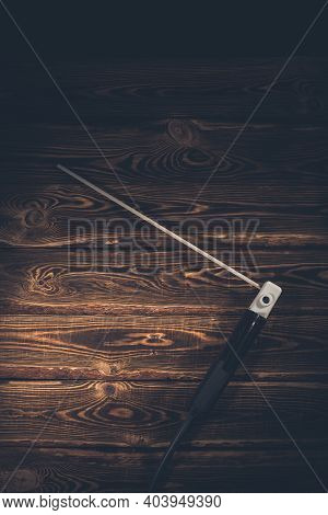 Welding Electrode Holder With Electrode On A Wooden Background. Studio Photo In Hard Light.