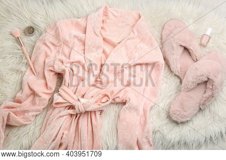 Flat Lay Composition With Fluffy Slippers And Bath Robe On Fuzzy Carpet. Comfortable Home Outfit