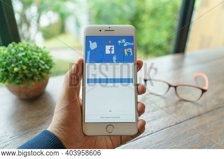 Chiang Mai, Thailand - Sep. 20,2020: Woman Holds  Apple Iphone 8plus With Facebook Application On Th