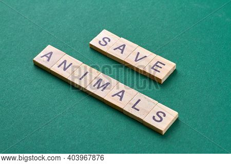 Save Animals Concept. Words Made Of Wooden Blocks Isolated On Green Background.