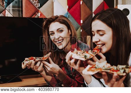 Group Of Friends Gathering Around Coffee Table At Home. Friends Gathered At The Table And Drinking B
