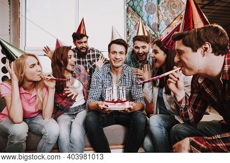 Group Of Friends Gathering Around Coffee Table At Home. Friends Gathered At The Table And Drinking B
