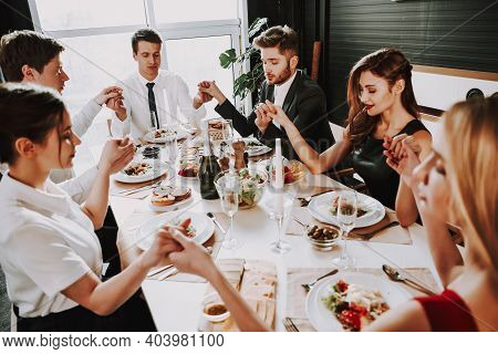 Group Of Friends Gathering Around Coffee Table At Home. Friends Gathered At The Table And Drinking B