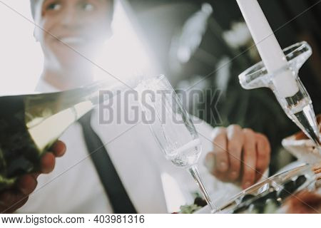 Group Of Friends Gathering Around Coffee Table At Home. Friends Gathered At The Table And Drinking B