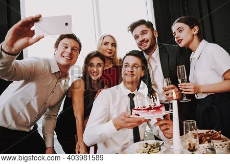 Man Is Proposing To Woman With Engagement Ring Near Window. A Man Puts A Ring On A Woman Who Has Bee