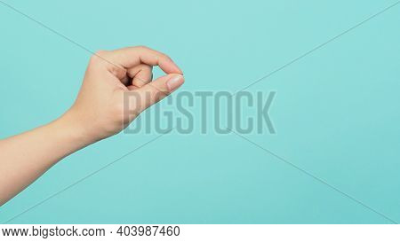 Empty Hand Holding Or Catch Nothing Guesture On Green And Blue Or Mint Background.