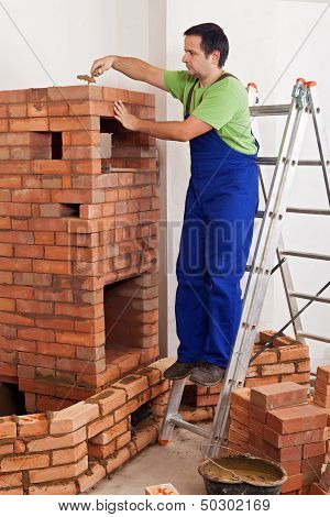 Worker Building Masonry Heater