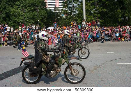 KUALA LUMPUR - AUGUST 31: Scrambler bikes from the infantry scout platoon take to the city streets in a parade as Malaysians celebrate Independence Day on August 31, 2013 in Kuala Lumpur, Malaysia.